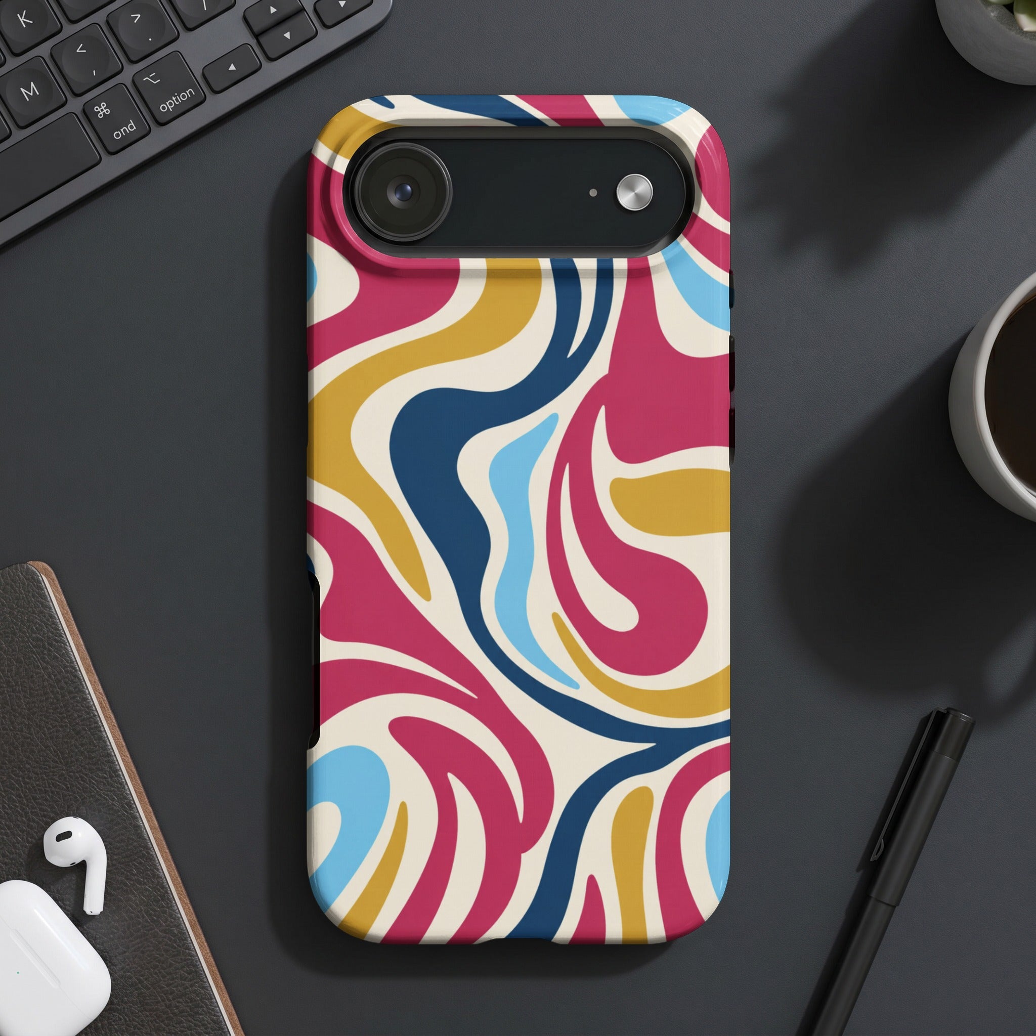 Phone case with retro swirl pattern in pink, yellow, blue, and cream.