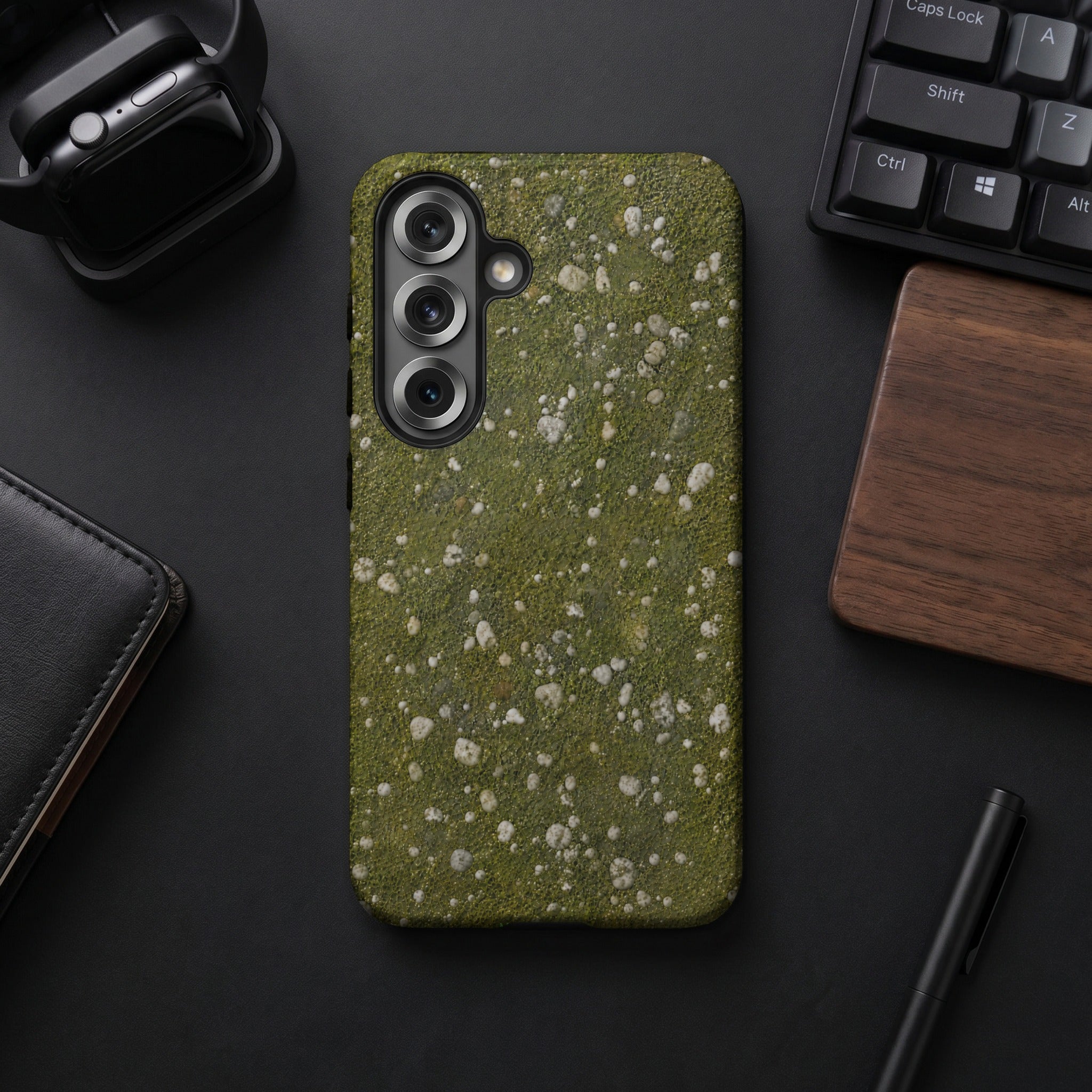 Phone case with green moss and white speckle texture, surrounding a camera array.