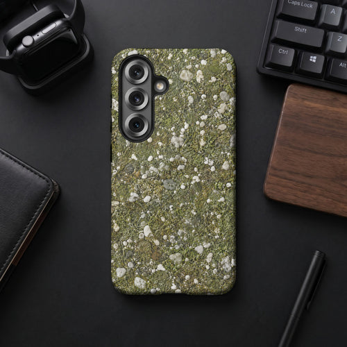 Phone case with a green moss and pebble pattern, featuring a triple camera array.