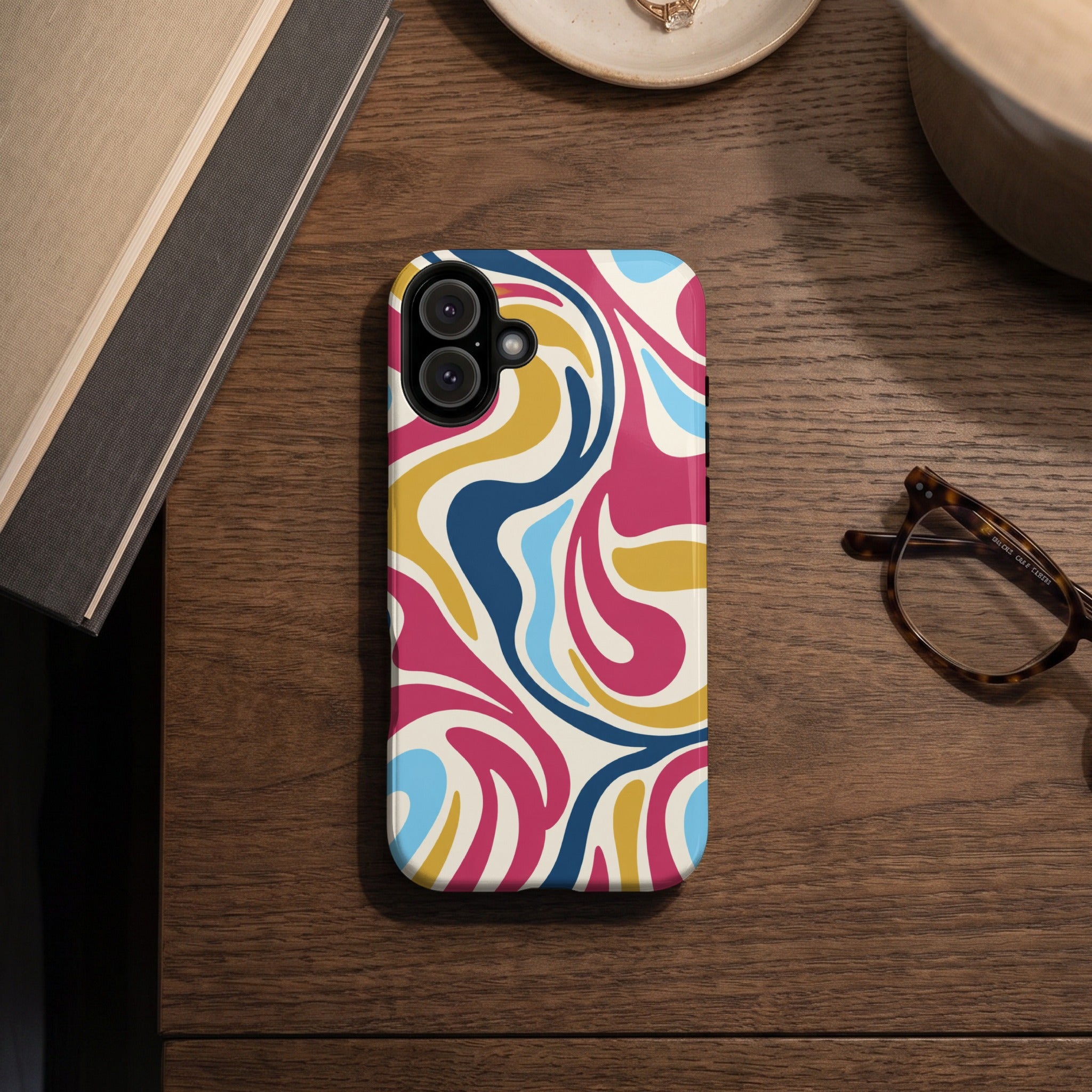 Phone case with a colorful swirling abstract pattern on a wooden surface.